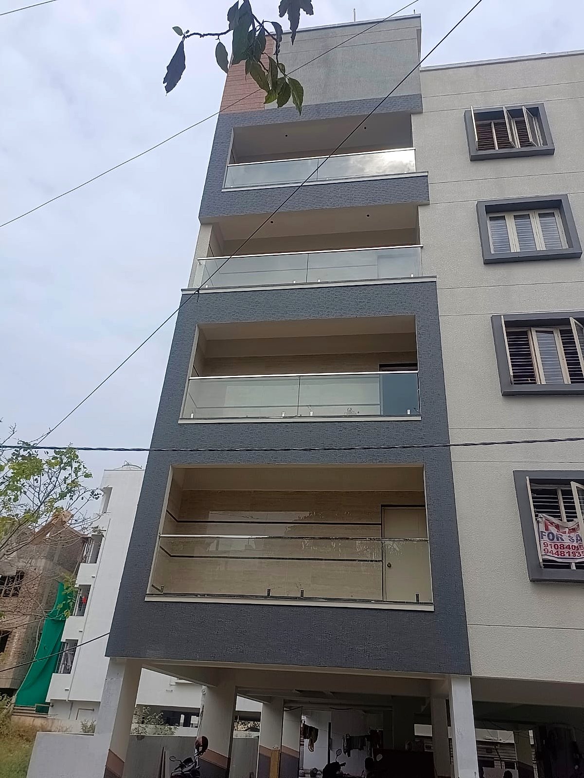 Balcony glass, grey facade